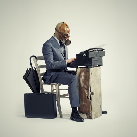 business wearing a gas mask, write with an old typewriterの写真素材
