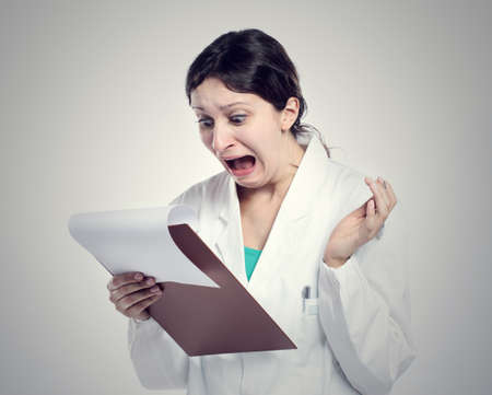 Being scared. Portrait Of A Young Woman Doctor の写真素材