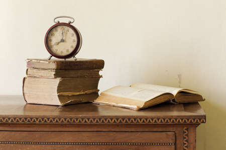 old alarm clock on old books, copy spaceの写真素材