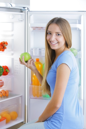 Young woman takes an appleの写真素材