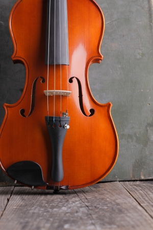 Close up of a violin on old wood backgroundの写真素材