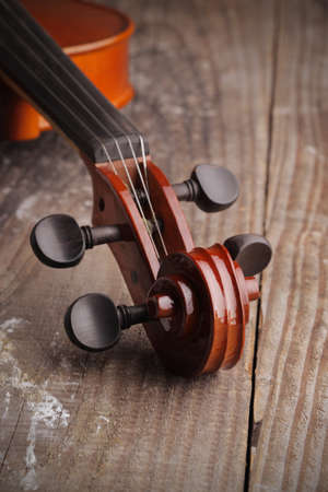Close up of a violin on old wood backgroundの写真素材