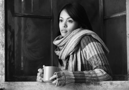 Portrait of a beautiful woman  with a cup of coffee or teaの写真素材