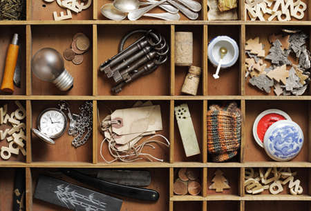 group of old objects in a drawer with compartmentsの写真素材