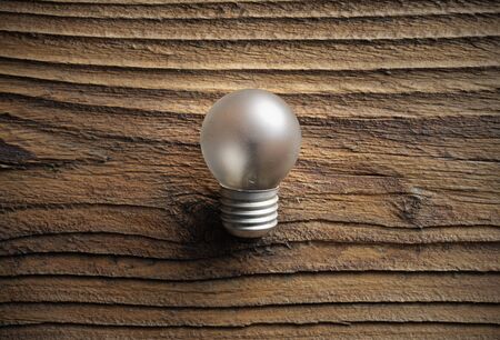 old light bulb on wooden backgroundの写真素材