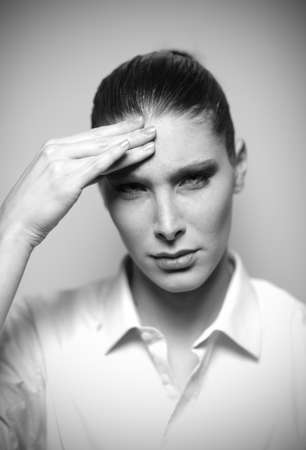 Beautiful woman having headache with hands on temple, shallow deep of fieldの写真素材