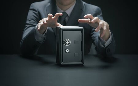 Hands reaching for a safeの写真素材