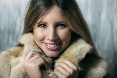 Portrait of young smiling woman in winter clothes の写真素材