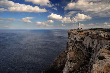 Landscape with a lighthouse on the cliffの写真素材