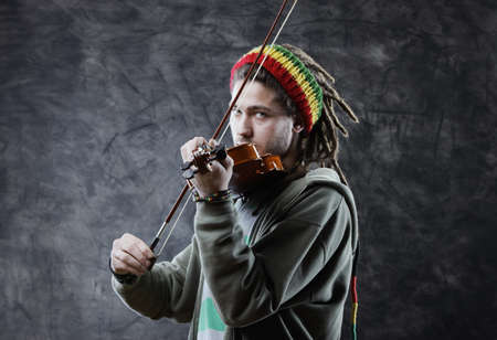 Rasta man musician playing violinの写真素材