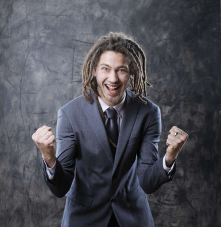 Happy business man celebrates successの写真素材