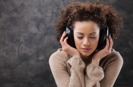 Young beautiful woman listening to music with headphonesの写真素材