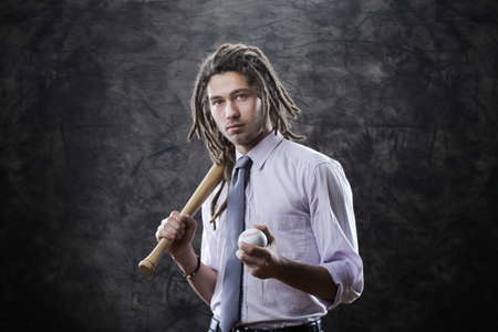 Portrait of young businessman with baseball batの写真素材
