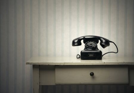 Old-fashioned phone on a wooden tableの写真素材