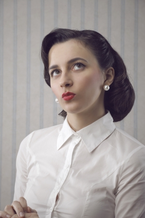 Portrait of beautiful retro business woman looking upの写真素材