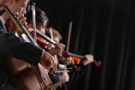 Symphony concert, a man playing the cello, hand close upの写真素材