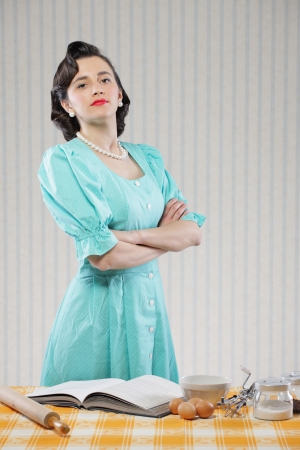 Vintage portrait of a housewife in the kitchenの写真素材