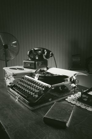Old typewriter on a wooden desk in officeの写真素材