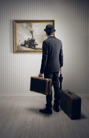 Man with suitcases waiting for the train, conceptual photoの写真素材