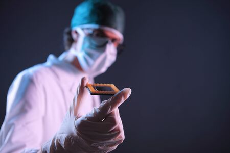 Computer engineer examining a microchip cpuの写真素材