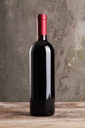 Red wine bottle on wooden backgroundの写真素材