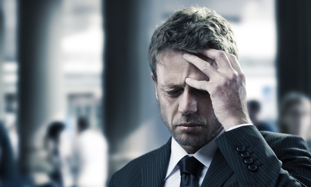 Portrait of a mature business man with headacheの写真素材