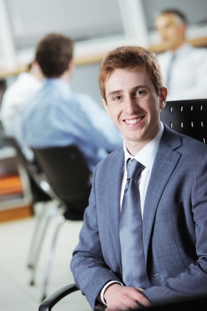 Young businessman with colleagues in the backgroundの写真素材