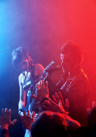 Rock band live. Rockstar singer on stageの写真素材