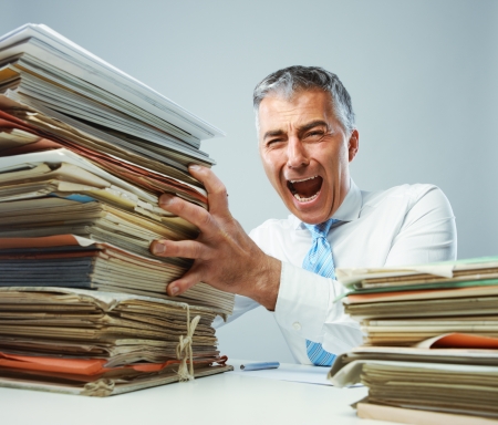 Overworked mature business man screaming in angerの写真素材