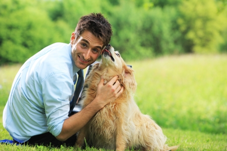 Young  man playing outdoors with his pet dog.の写真素材