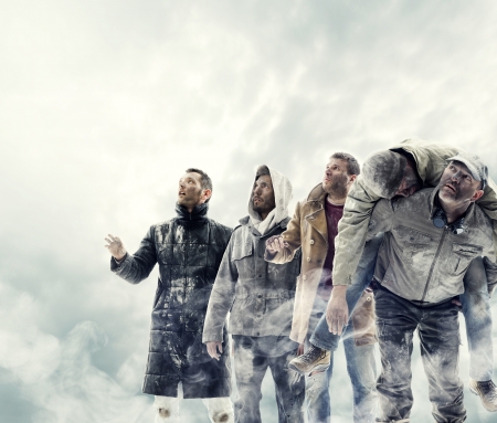 A group of people worried looking up to the sky