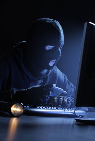 Computer hacker - Male thief stealing data from computer