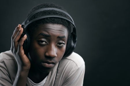 Portrait of african teenage listening music with headphones.の写真素材
