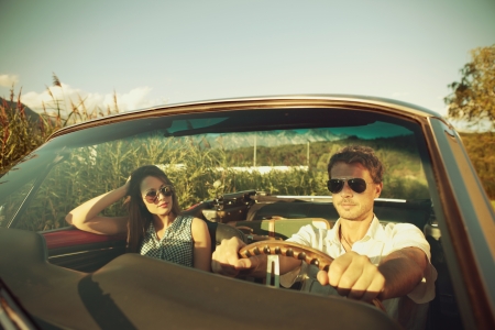 Couple taking a road trip in vintage convertibleの写真素材