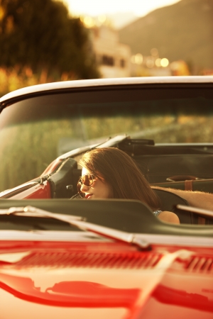 Young beautiful woman sleeping in a convertible car