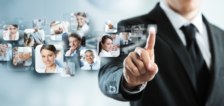 Businessman finger touches virtual buttonsの写真素材