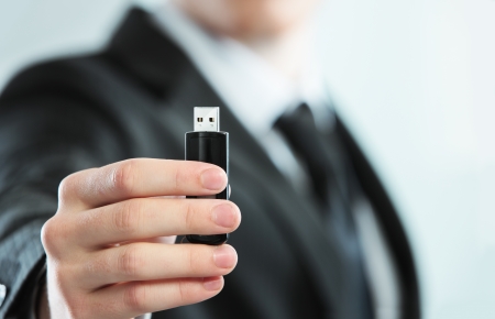 Businessman holds a USB key, close upの写真素材