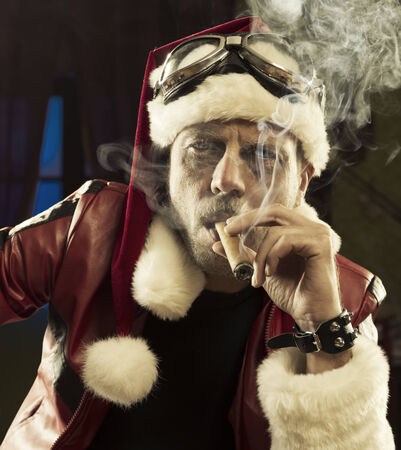 Portrait of Bad Santa smoking a cigar の写真素材