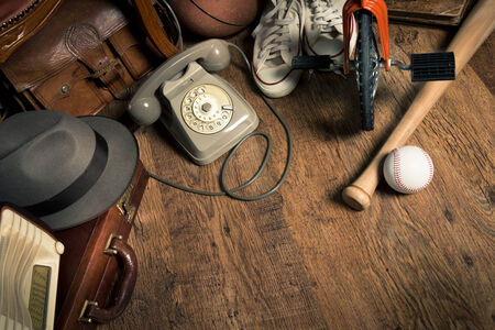 Group of assorted vintage items on hardwood floor at flea market.の写真素材