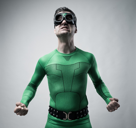 Funny green superhero snarling and ready to punch.の写真素材
