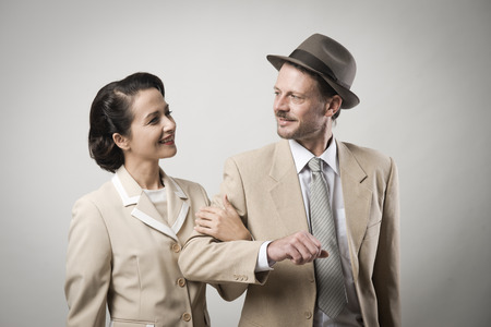Elegant vintage couple arm in arm, 1950s styleの写真素材