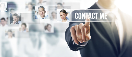 Businessman touching a ghost button on a touch screen interface, human resources and social networking conceptの写真素材