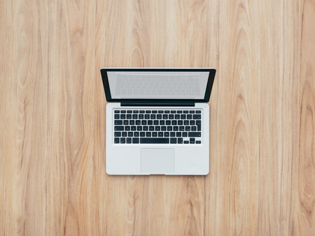 Professional contemporary design laptop on a wooden desktop, top viewの写真素材