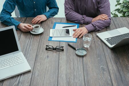 Business meeting in the office: two businessmen are working together at desk, teamwork and partnership conceptの写真素材