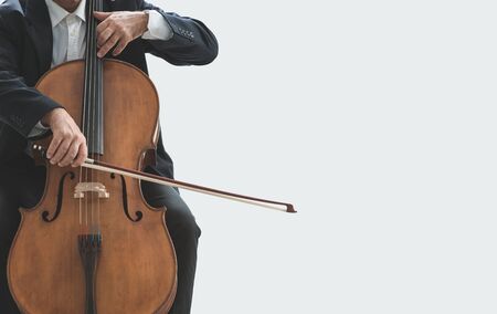 Professional male cellist playing his cello, classical music solo performanceの写真素材