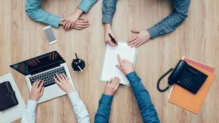 Couple having a meeting in a business office and signing a contract, top viewの写真素材