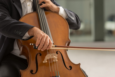Classical music professional cello player solo performance, hands close up, unrecognizable personの写真素材