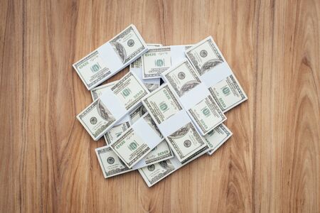 Load of cash money on a desktop: wealth, earning and winning concept