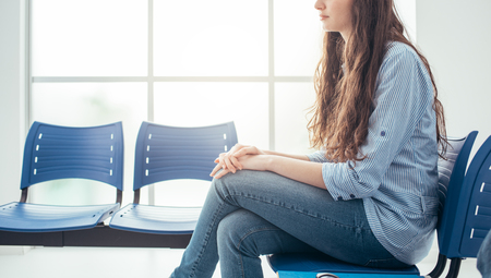 Young woman in the waiting room, she is waiting for an interviewの写真素材