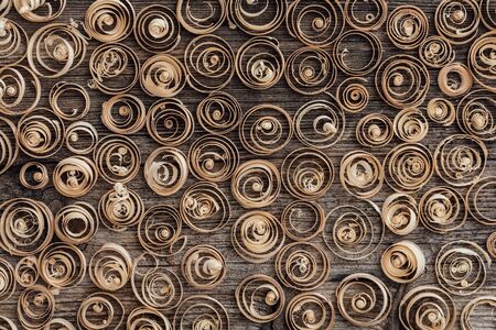 Wood spiral shavings on a vintage workbench background: carpentry, woodworking and craftsmanship...